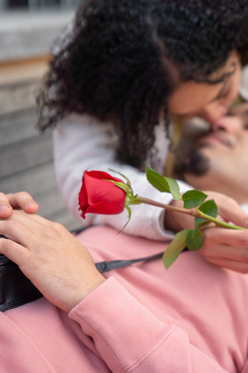 Young Hispanic Girl Kissing Boyfriend